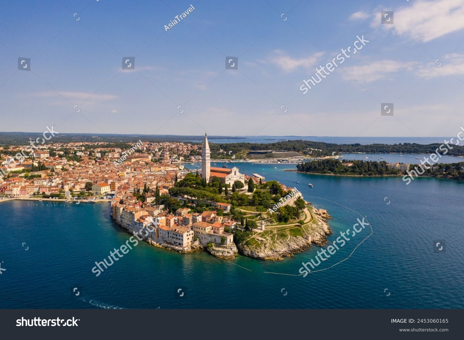 Rovinj, Croatia: Dramatic aerial view of the famous Rovinj medieval old town with its Venetian campanile in Istria by the Adriatic sea in Croatia #2453060165