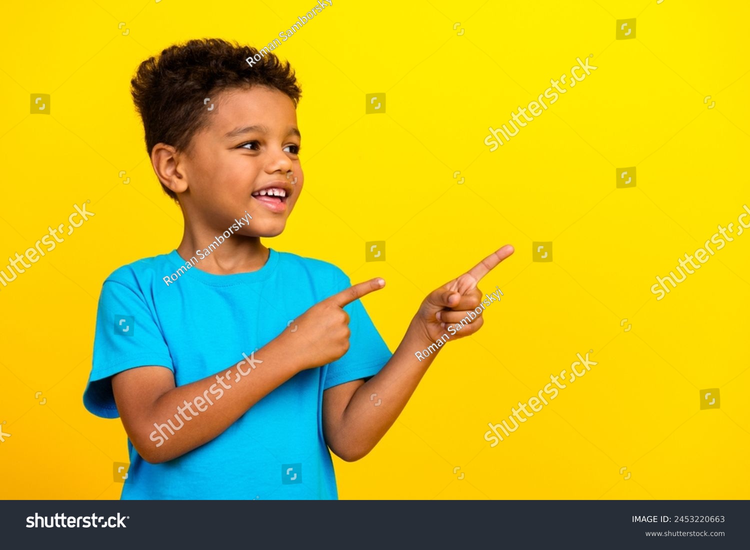 Portrait of mixed race multiethnic multinational schoolboy look directing at discount empty space isolated on vivid yellow background #2453220663