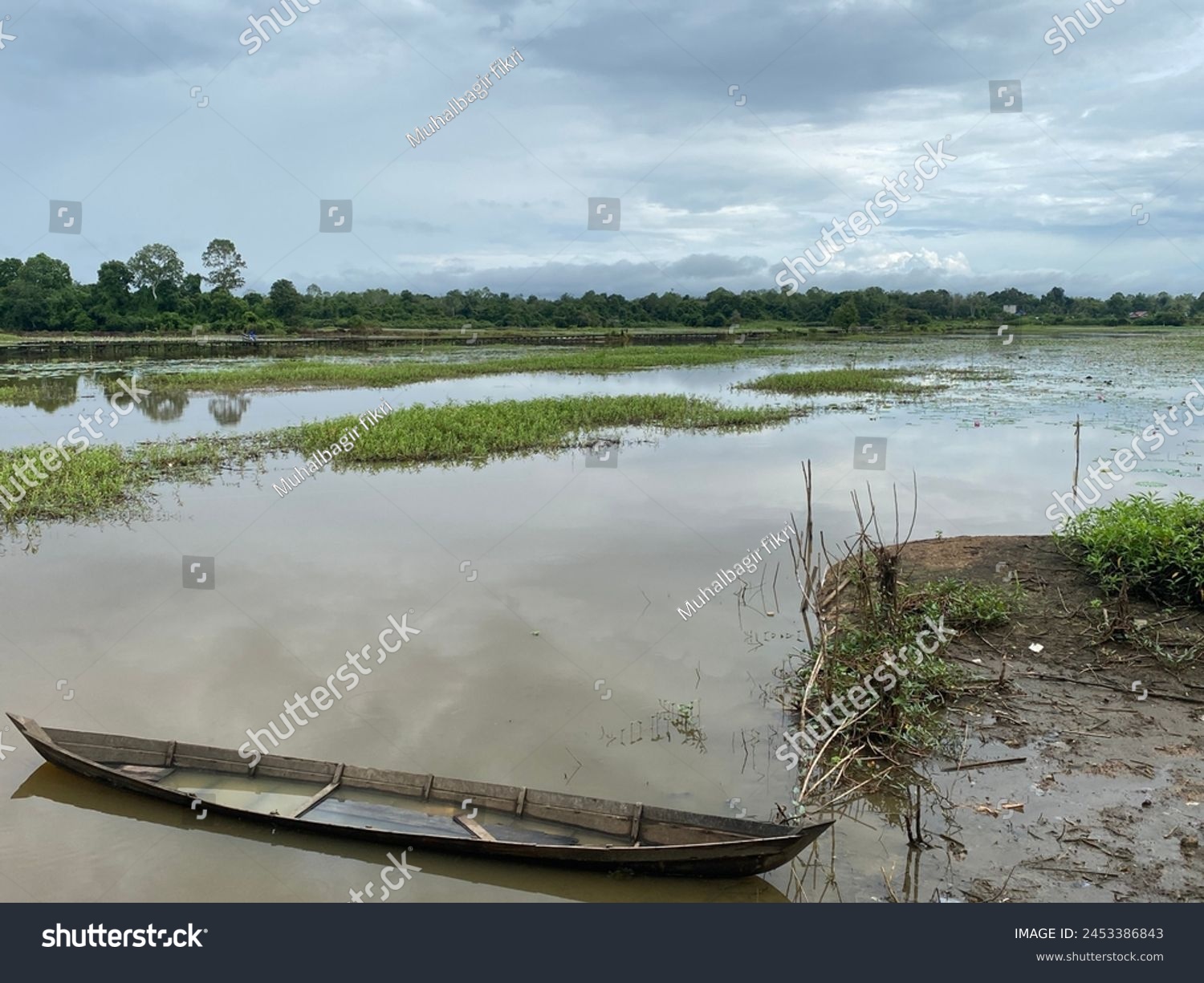 Rural areas in South Kalimantan. April 21, 2024. Old traditional wooden boat in village rice fields. Photo taken from a height. #2453386843