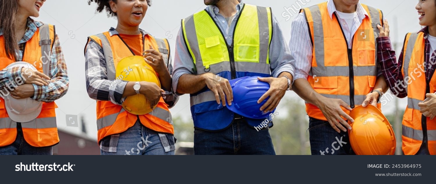 Engineer team holding hardhat standing in row ready for work.Worker diversity group wearing vest,ppe for safety in site train garage.Expert construction project manager leadership.banner cover design. #2453964975