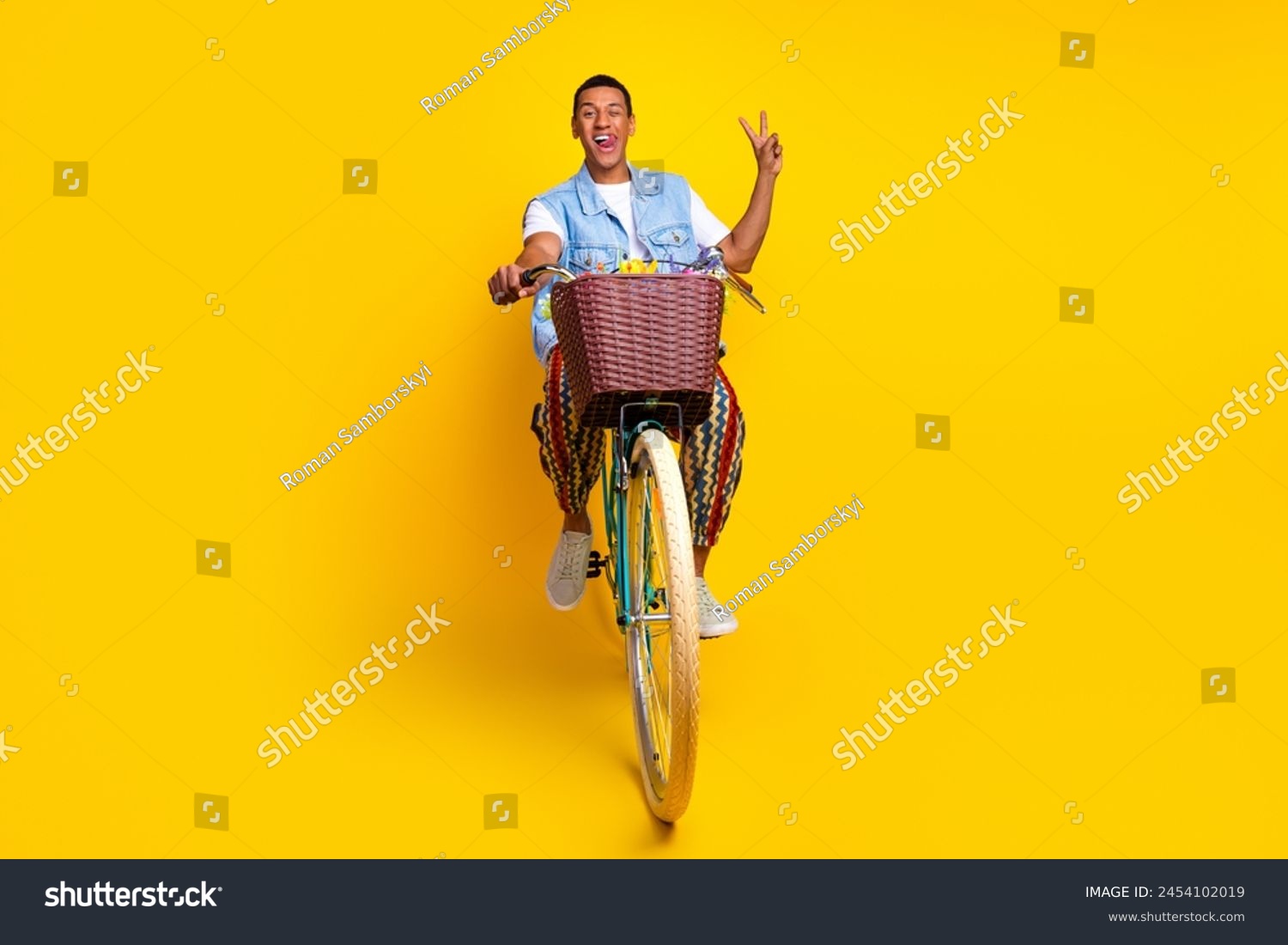 Full size photo of multiethnic multinational man dressed denim vest riding cycle show v-sign isolated on vibrant yellow color background #2454102019