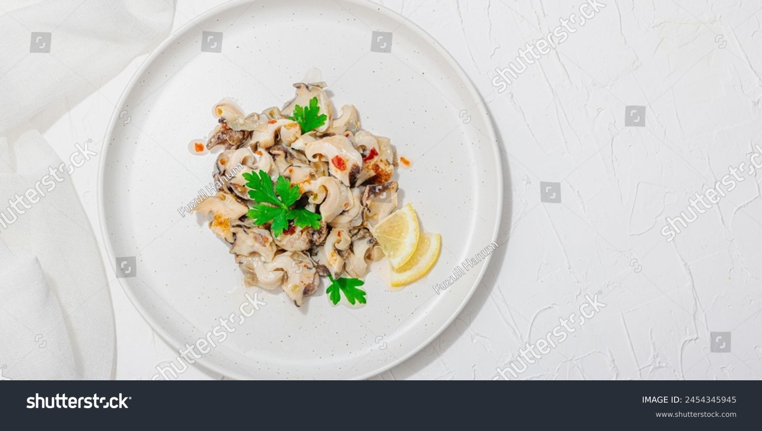 Rapana clam meat with oil, spices and greens. Healthy seafood is rich in omega. Marine decor, hard light, dark shadow, white plaster background, flat lay, banner format #2454345945