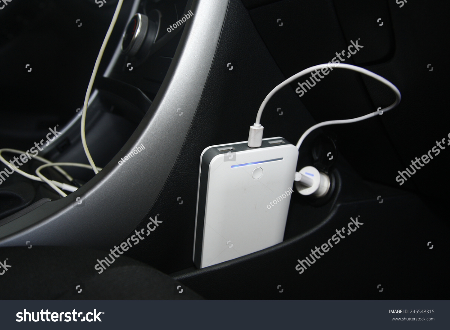 The car is charging the power bank from the usb socket. car interior #245548315