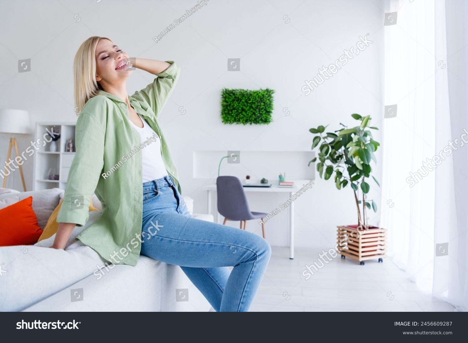 Photo of adorable sweet dreamy girl closed eyes enjoying sunny weekend morning in comfy modern interior room indoors #2456609287