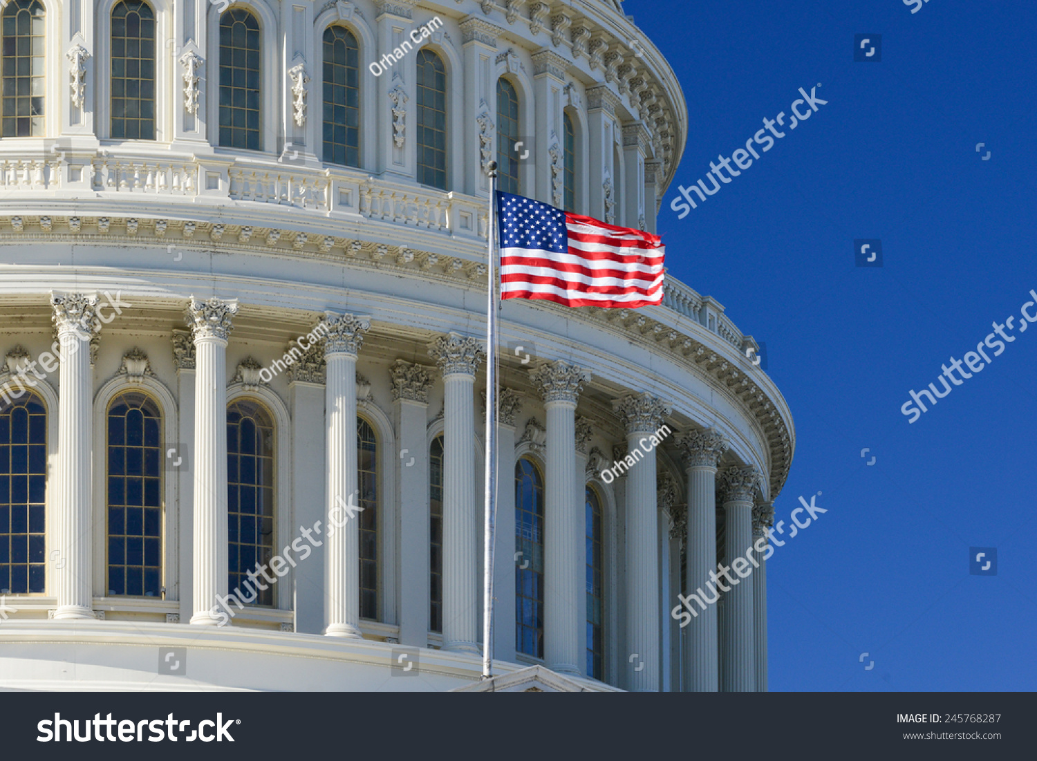 US Capitol Building dome detail with waving national flag - Washington DC, United States of America #245768287