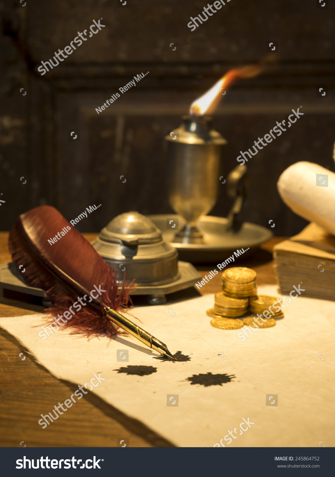 Antique Kitchen Candlelight antique parchment paper sheets lit by candlelight on a vintage colonial wood desk with ink writing feather quill and old candle light in candleholder in