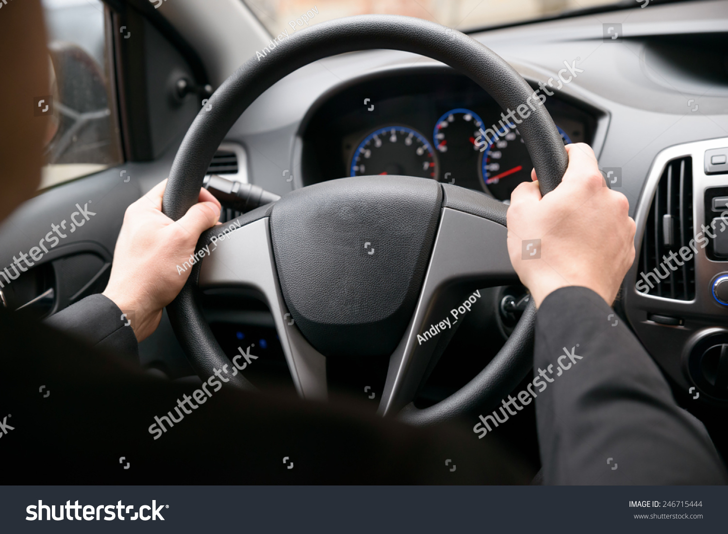 Close-up Of A Man Hands Holding Steering Wheel While Driving Car #246715444