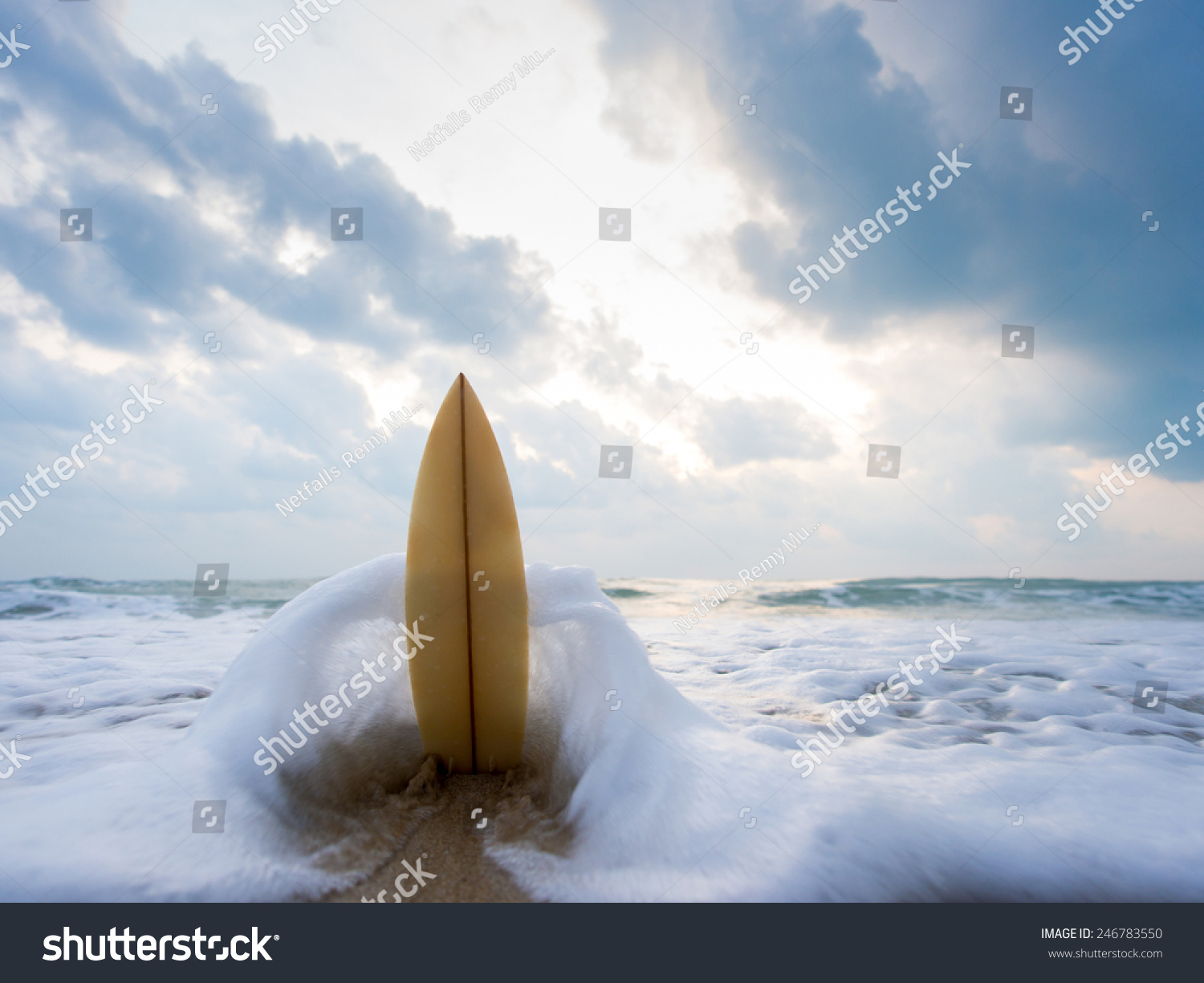 Surfboard on the beach at sunset #246783550