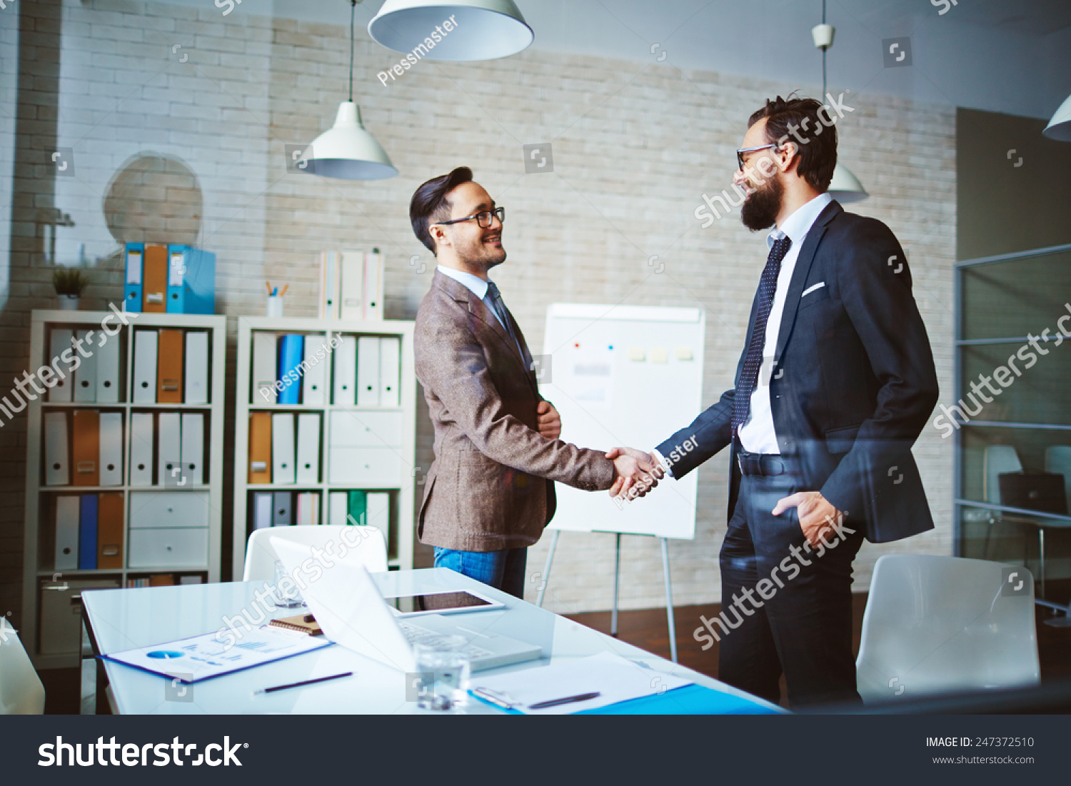 Successful businessmen handshaking after negotiation #247372510
