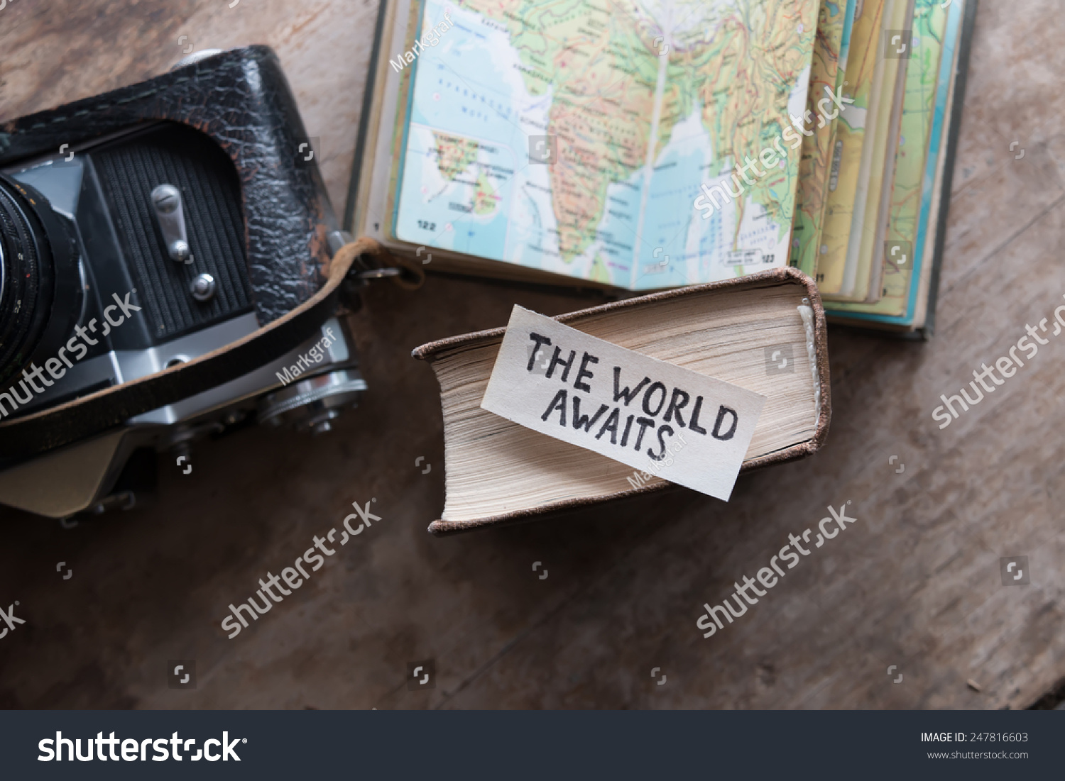 text "The World Awaits" and book, travel, tour, tourism concept #247816603