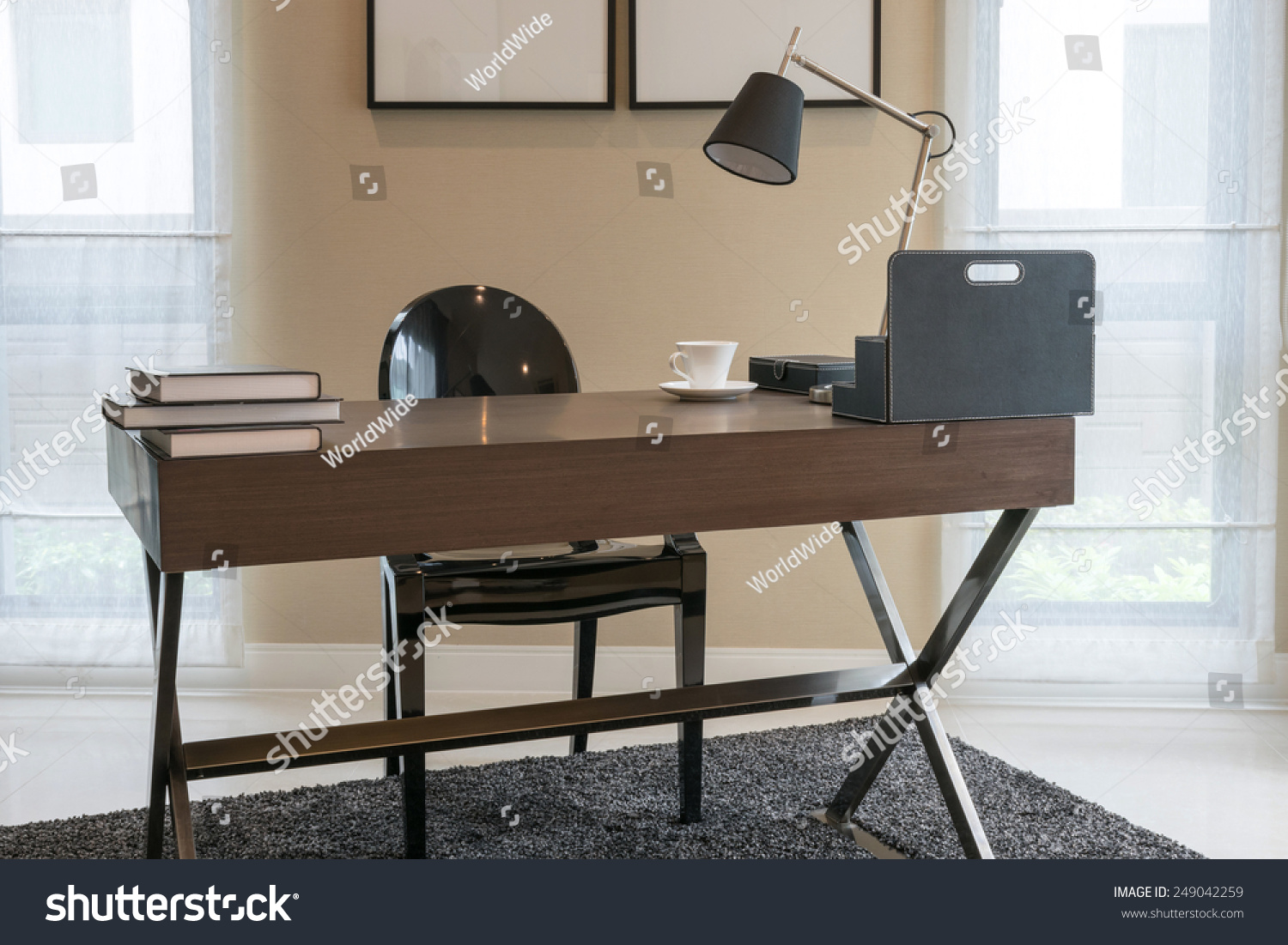 wooden table and books in modern working room interior #249042259