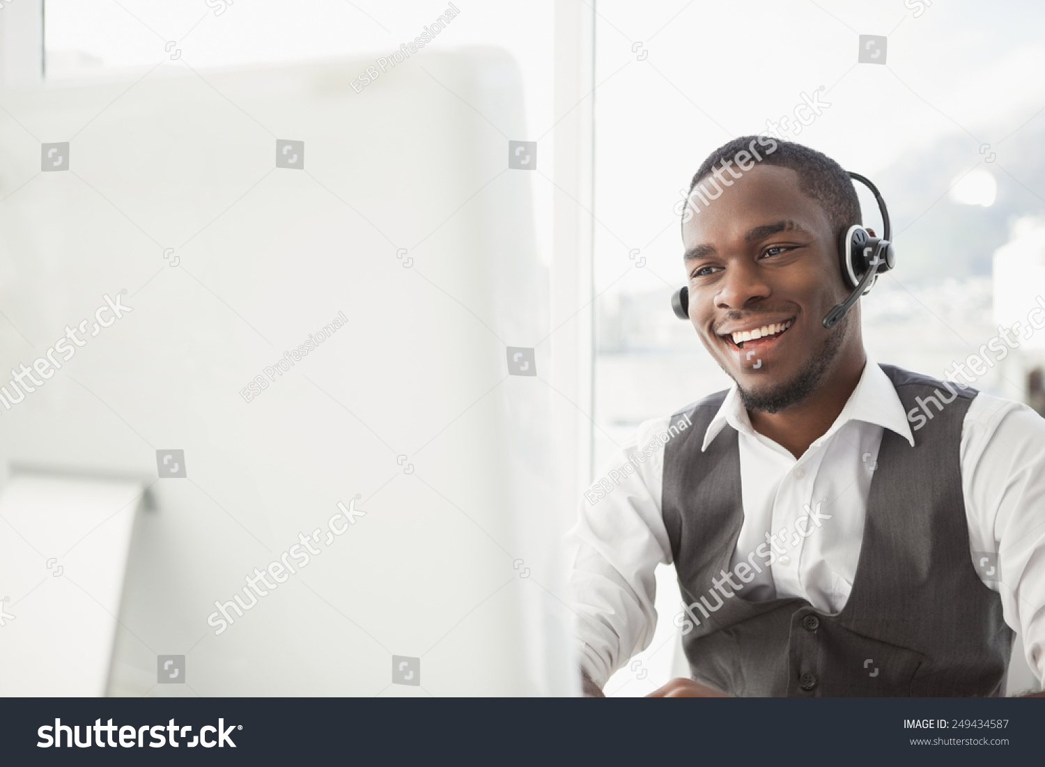 Smiling businessman with headset interacting in his office #249434587