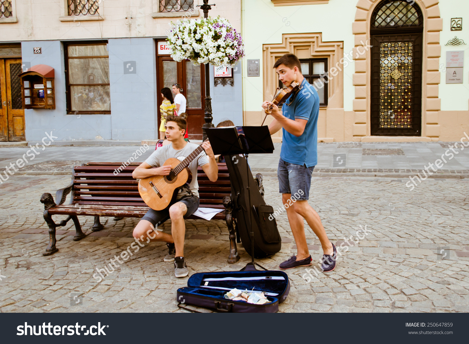 LVIV, UKRAINE - JULY 22: Street musicians on a central square of the city in the Ukraine on July 22, 2014 in Lviv. #250647859