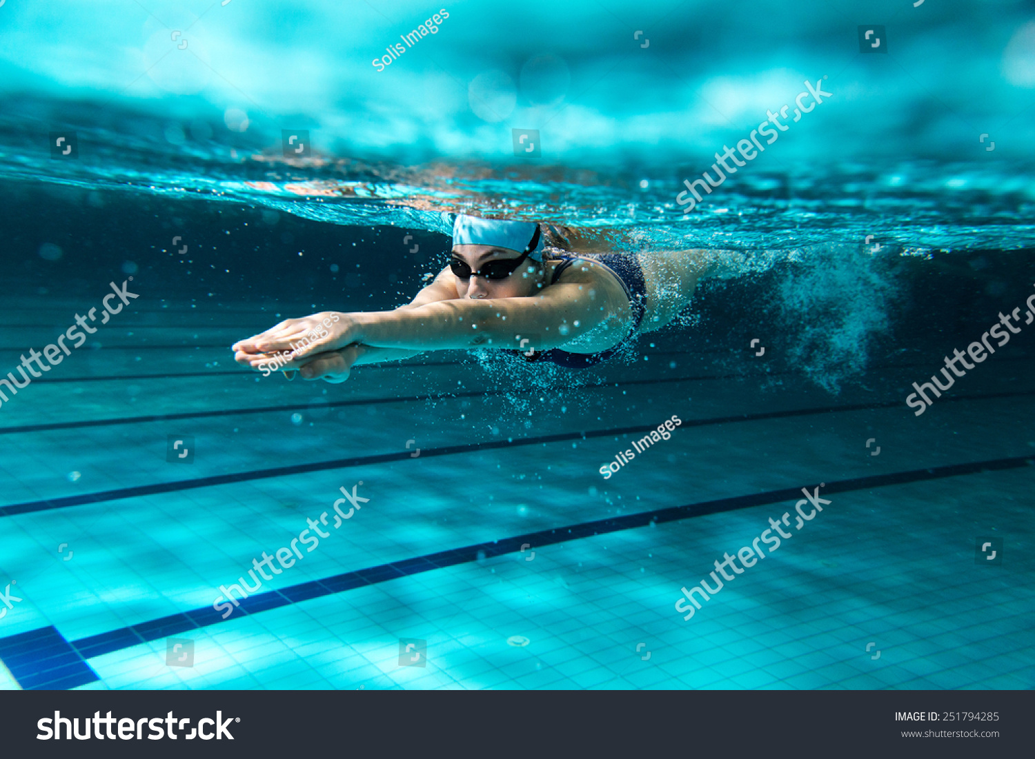Female swimmer at the swimming pool.Underwater photo. #251794285