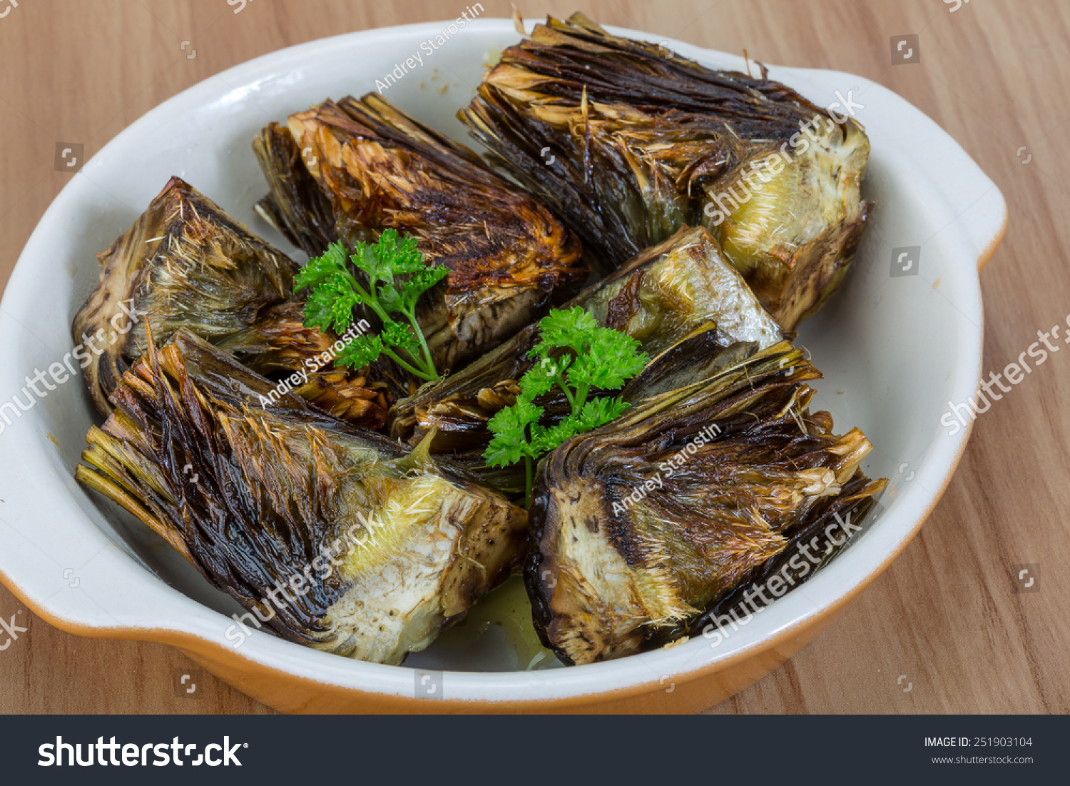 Grilled artishokes with parsley on the wood background #251903104