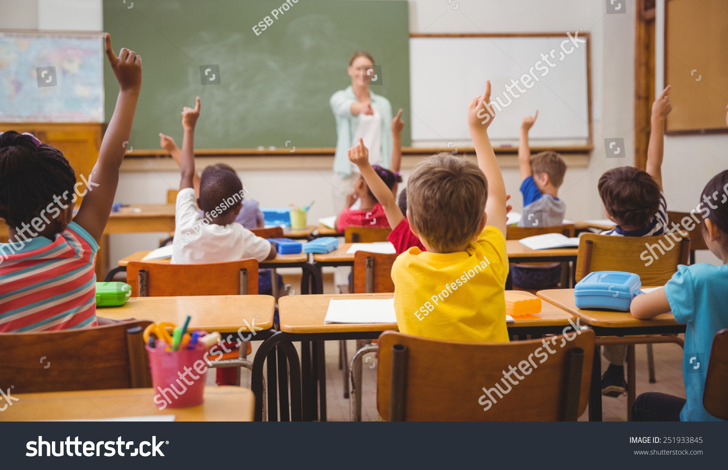 Pupils raising their hands during class at the elementary school #251933845