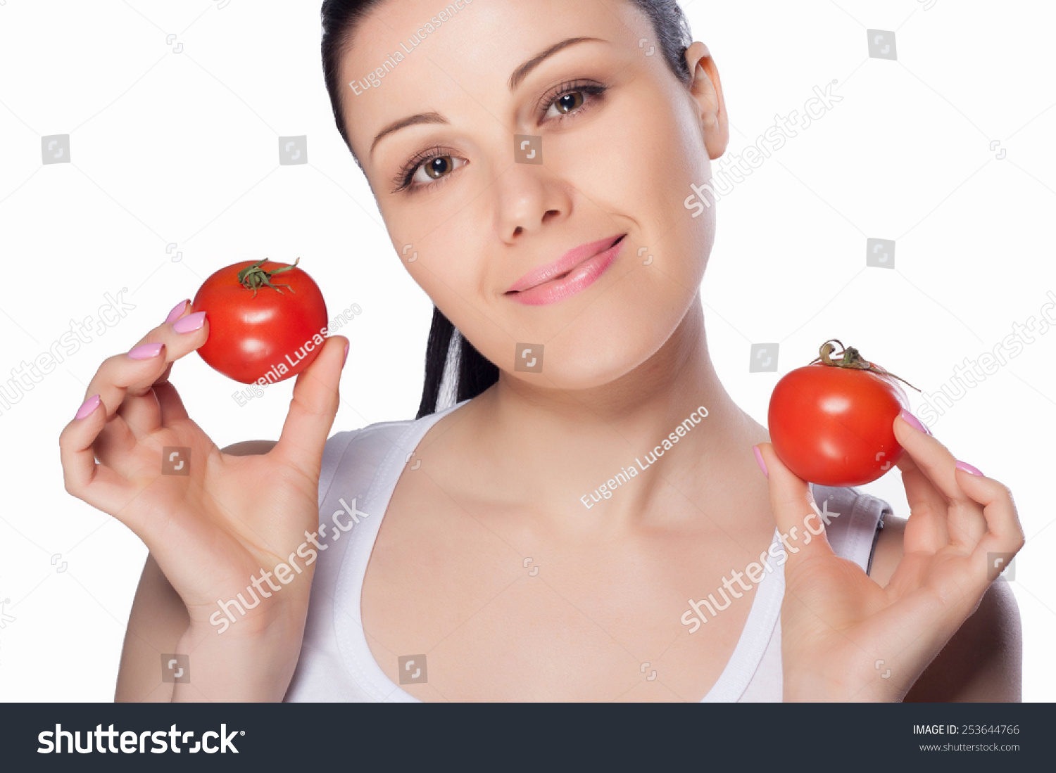 Beautiful close-up portrait of young woman with tomato. Healthy food and vegetables concept. Skin care and beauty. Vitamins and minerals. #253644766
