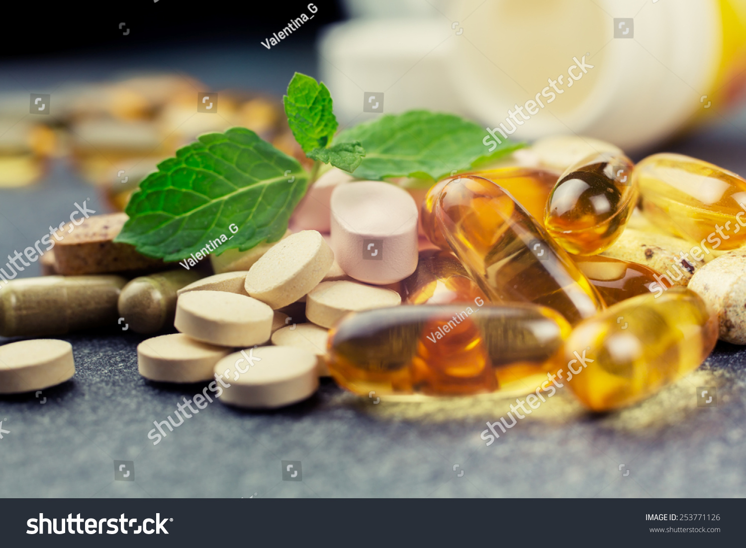 pills and multivitamins on a dark background, closeup #253771126