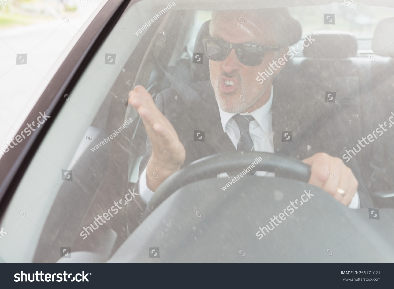 Nervous man sitting at the wheel in his car #256171021