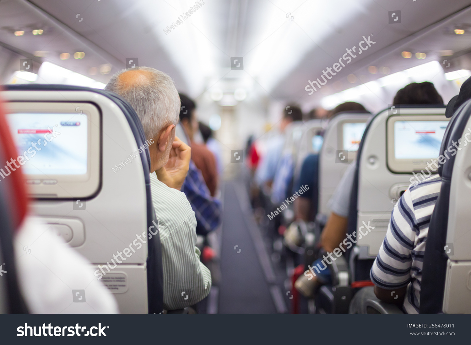 Interior of airplane with passengers on seats waiting to taik off. #256478011