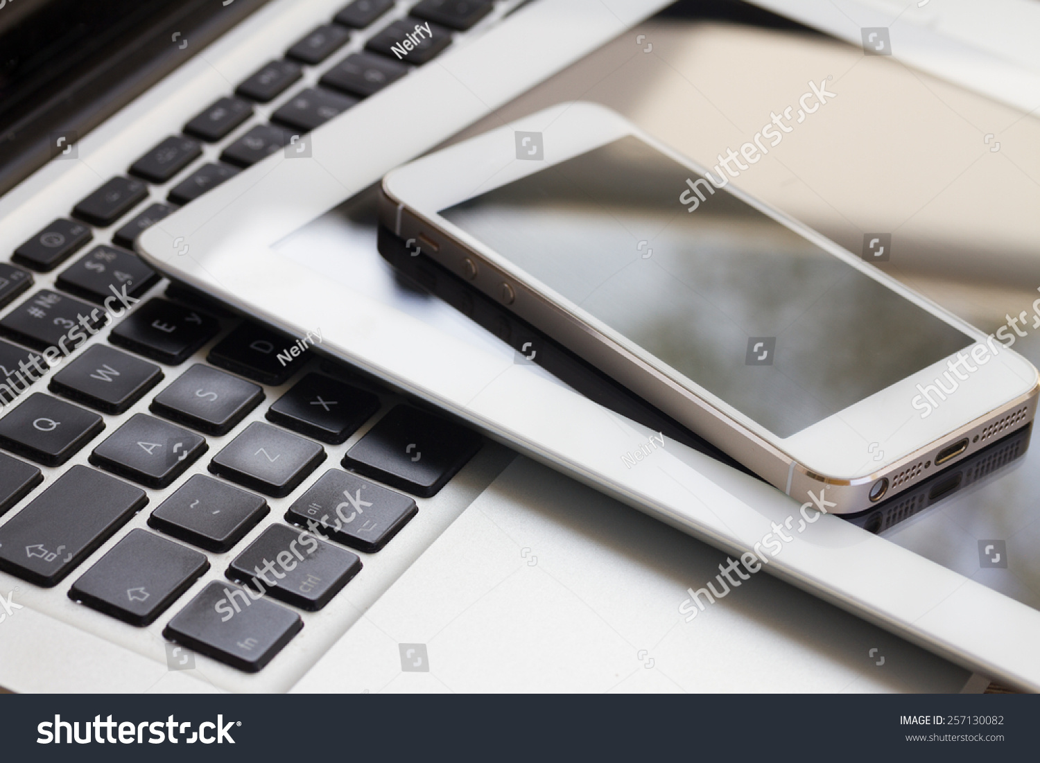 set of modern computer devices  - laptop, tablet and phone close up #257130082