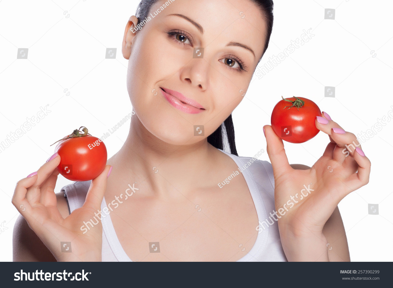 Beautiful close-up portrait of young woman with tomato. Healthy food and vegetables concept. Skin care and beauty. Vitamins and minerals. #257390299
