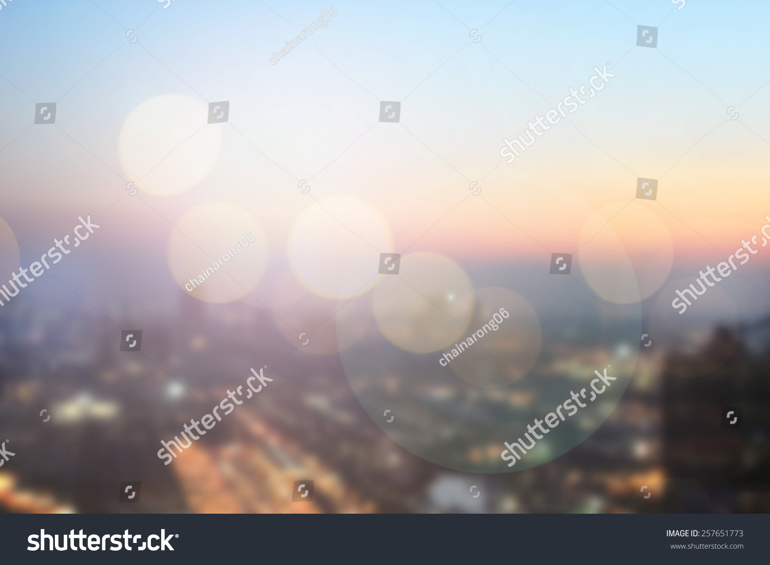abstract double exposure of blurred sky night city downtown construction with circle round light background with lens flare effect concept. #257651773