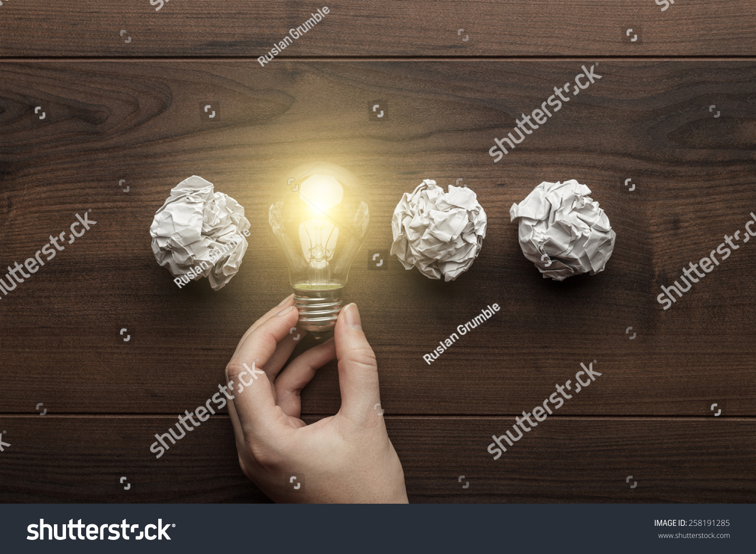 new idea concept with crumpled office paper, female hand holding light bulb #258191285
