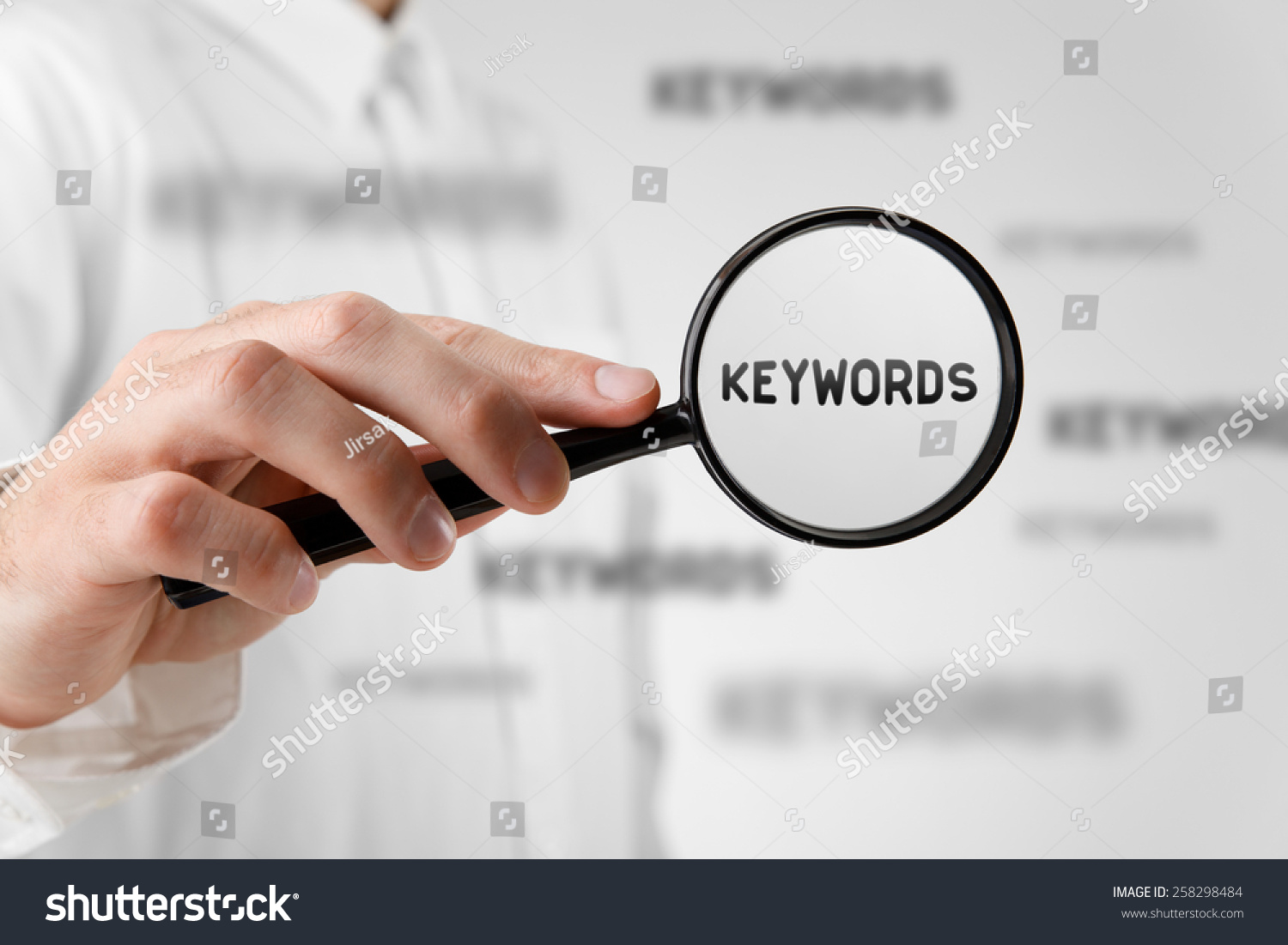 Find keywords concept. Marketing specialist looking for keywords (concept with magnifying glass).  #258298484
