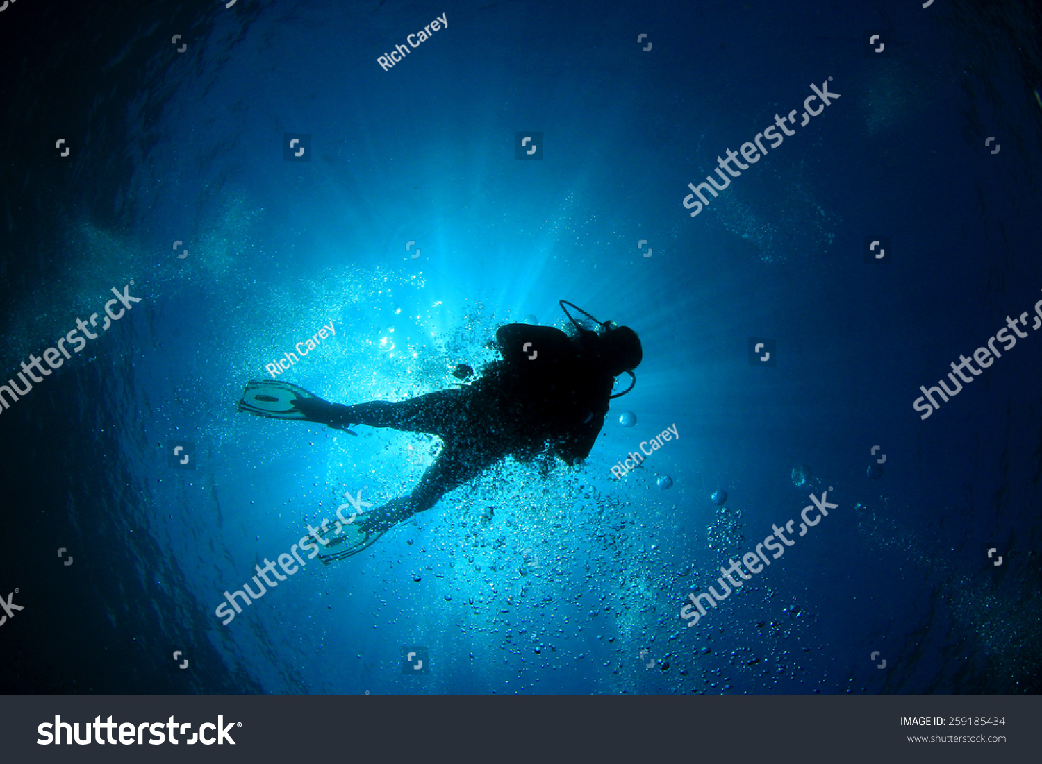 Scuba diver silhouette and sun #259185434