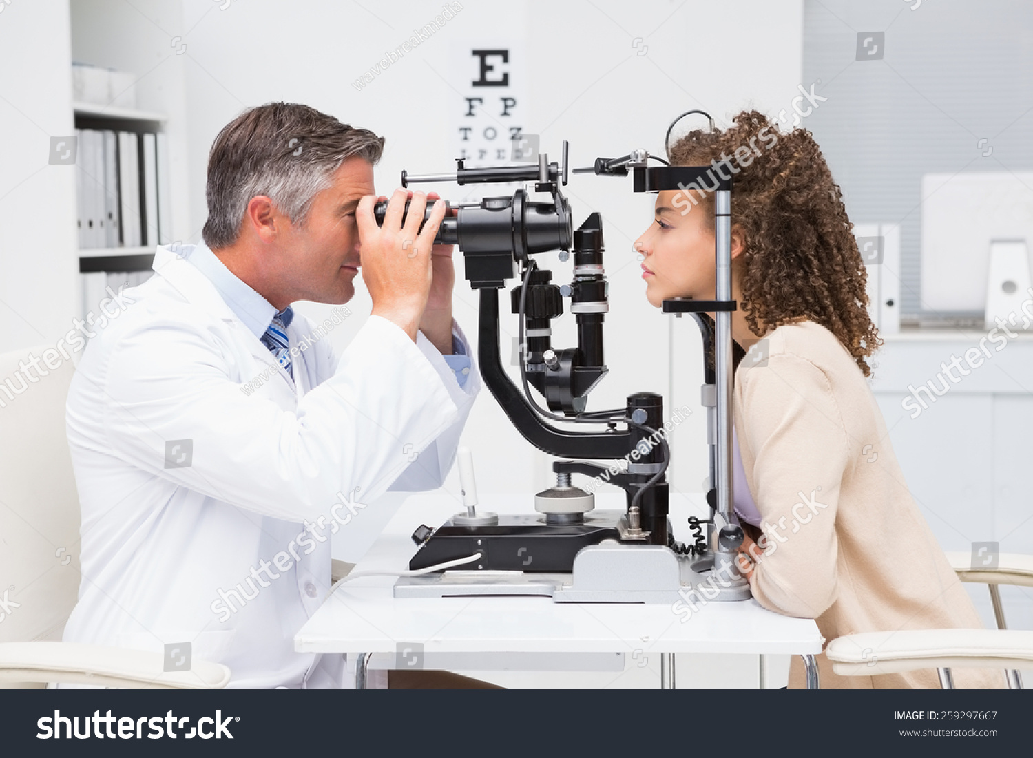 Woman doing eye test with optometrist in medical office #259297667