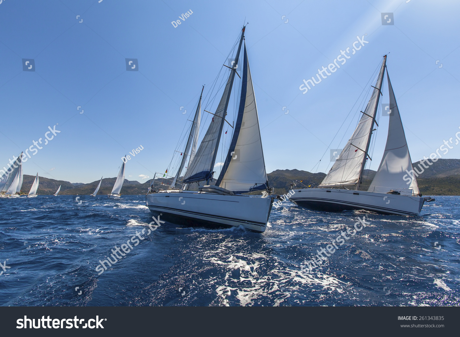 Sailing yacht race. Sailing ships yachts with white sails in the open sea. #261343835