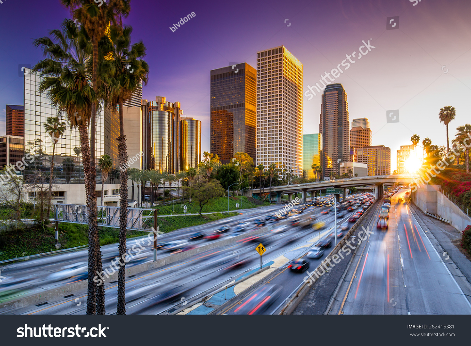 Los Angeles downtown buildings and highway car traffic at sunset #262415381