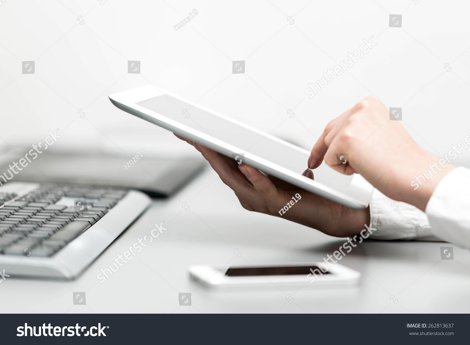 close up hands multitasking woman using tablet, laptop and cellphone connecting wifi in office #262813637
