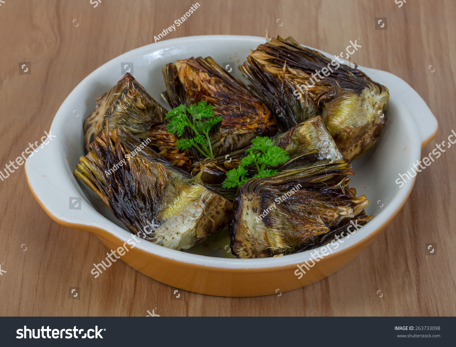 Grilled artishokes with parsley on the wood background #263733098