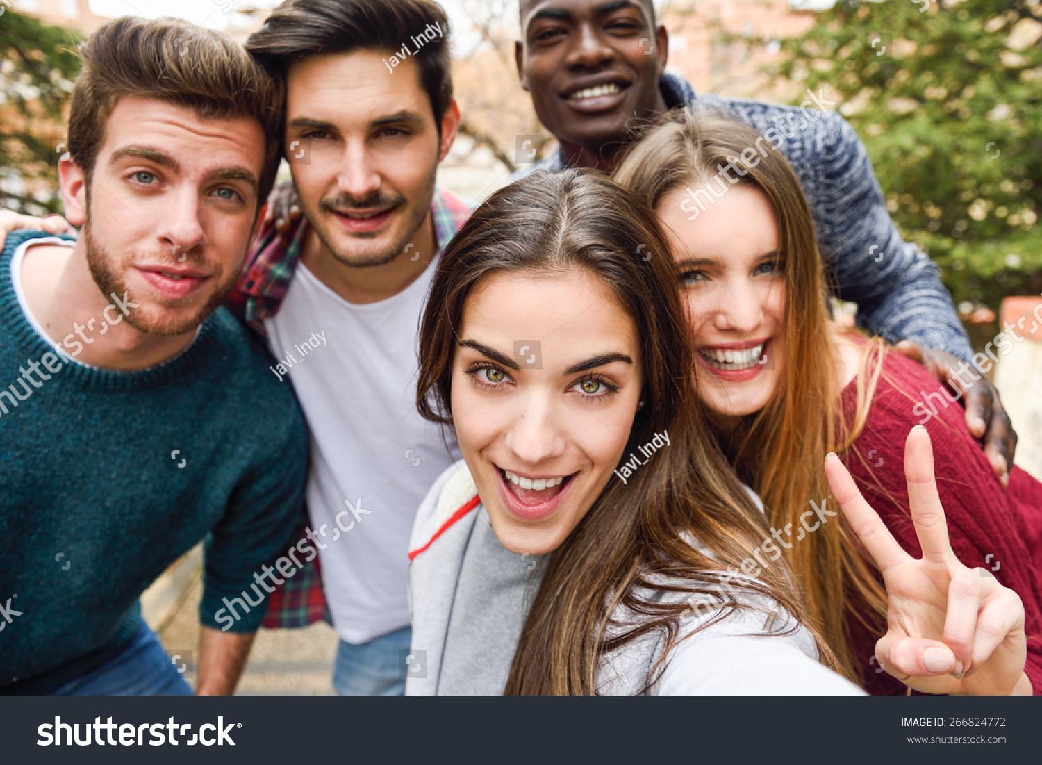 Group of multi-ethnic young people having fun together outdoors #266824772