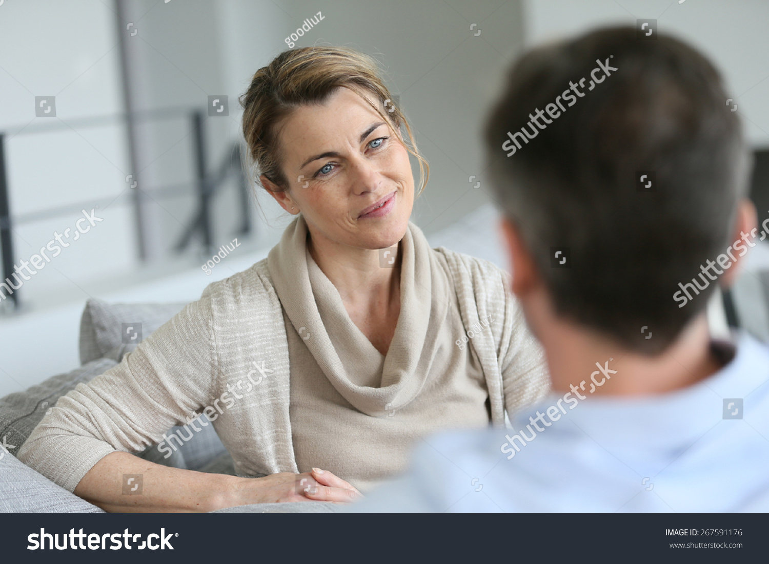 Couple at home sitting in sofa and having a talk #267591176