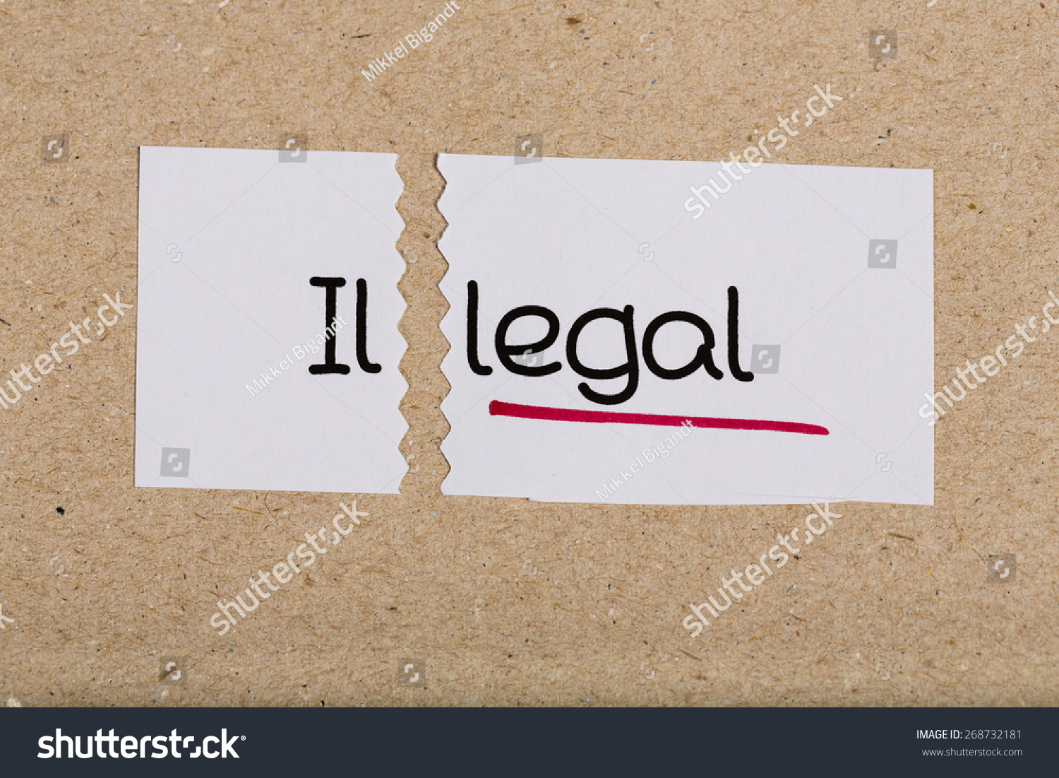 Two pieces of white paper with the word illegal turned into legal #268732181