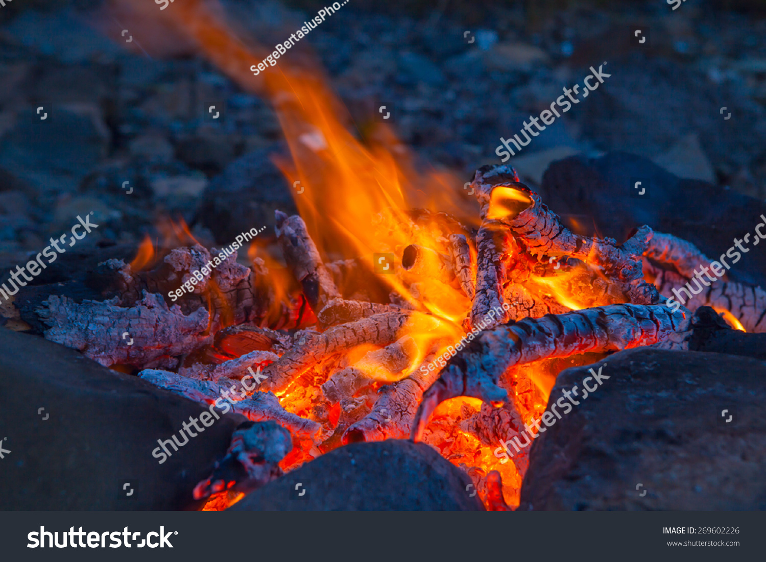 Classic camping campfire in rock fire ring at dusk closeup #269602226