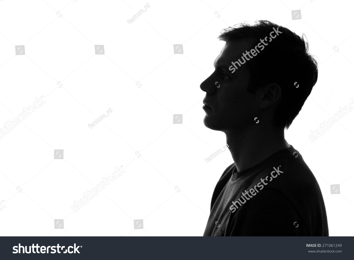 black-and-white silhouette of head of sad caucasian man on a white isolated background #271061249