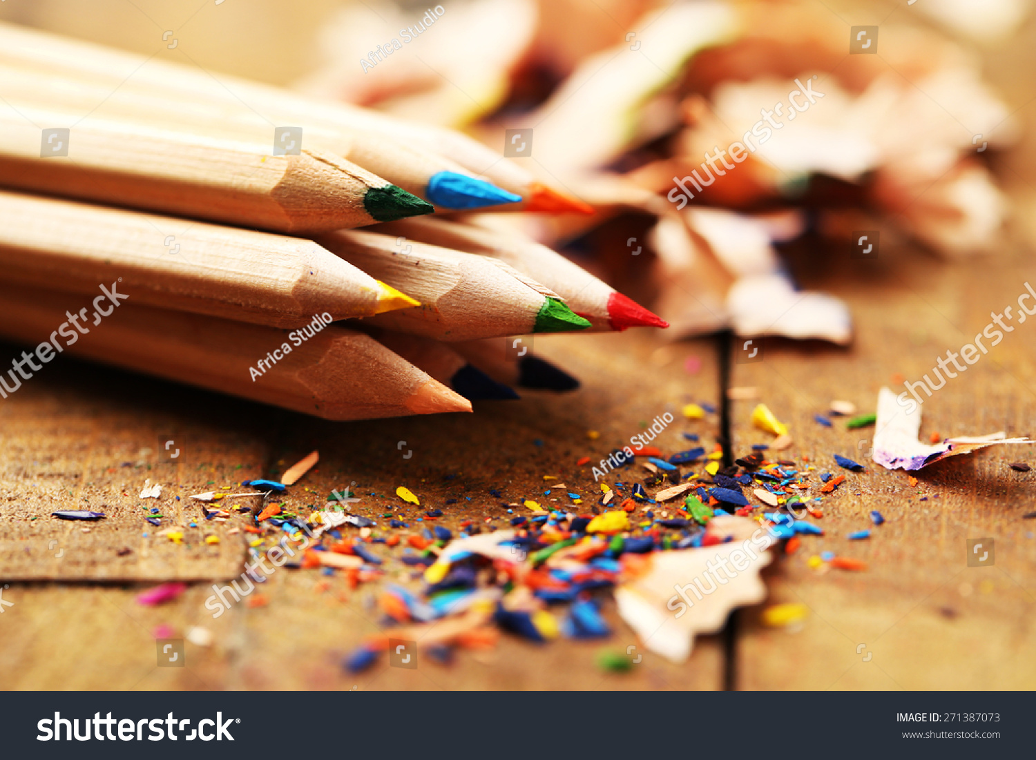 Wooden colorful pencils with sharpening shavings, on wooden table #271387073