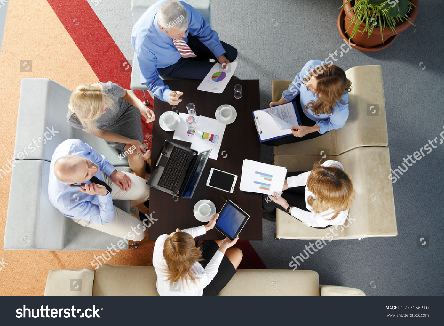 Image from above of business people sitting around the desk and working on presentation. Teamwork at office.  #272156210