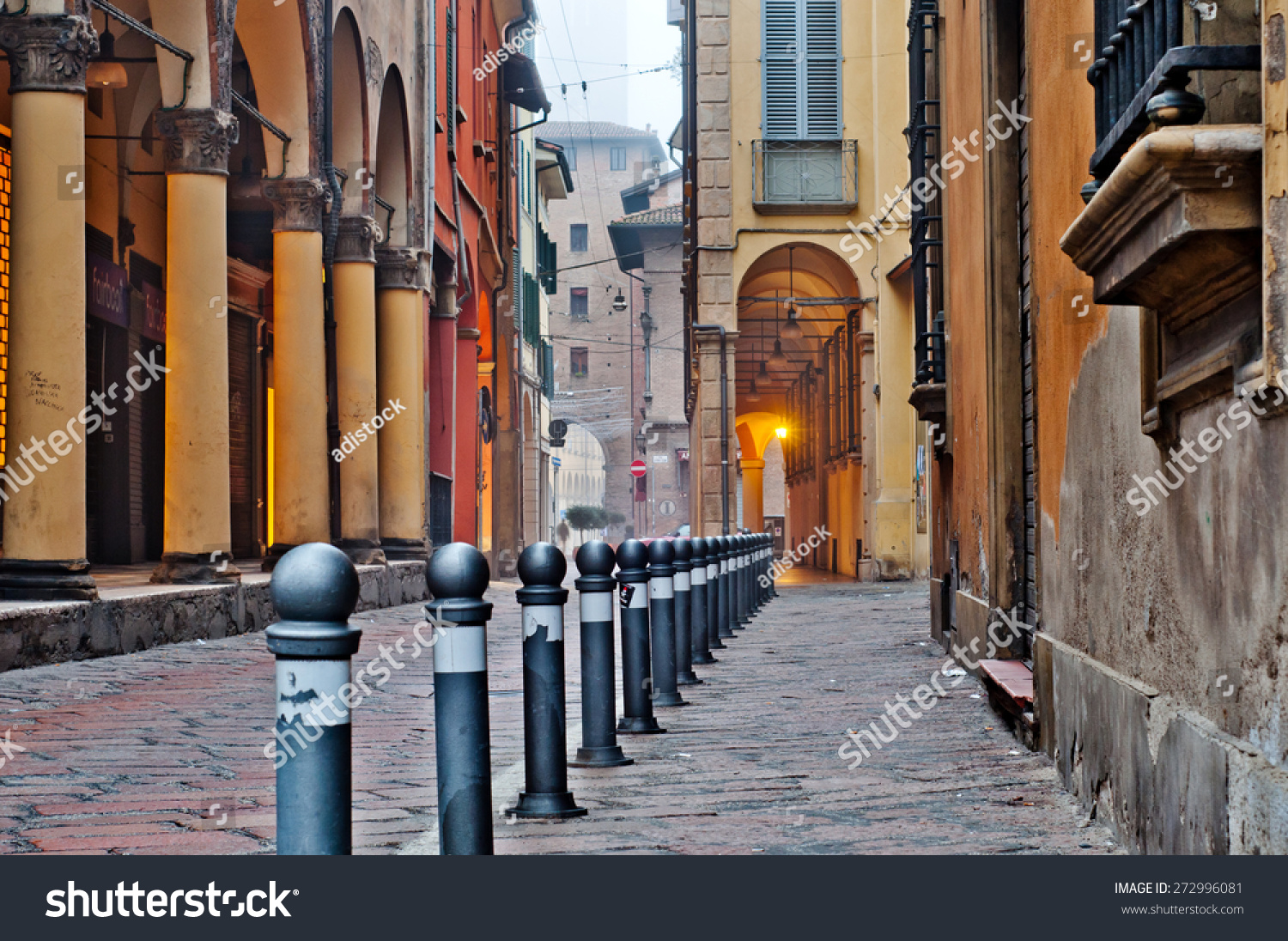 Old street view Bologna city, Italy. Cobble stone street with bollards. Renaissance buildings. #272996081