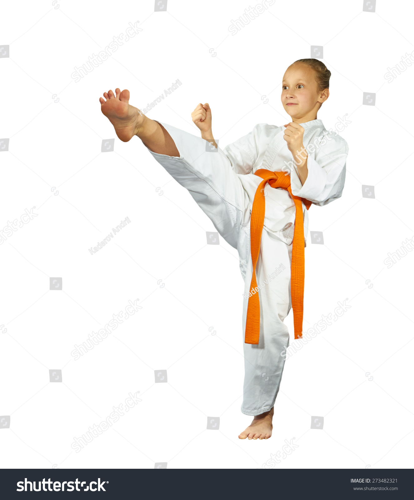 Girl with red belt makes the high kick #273482321