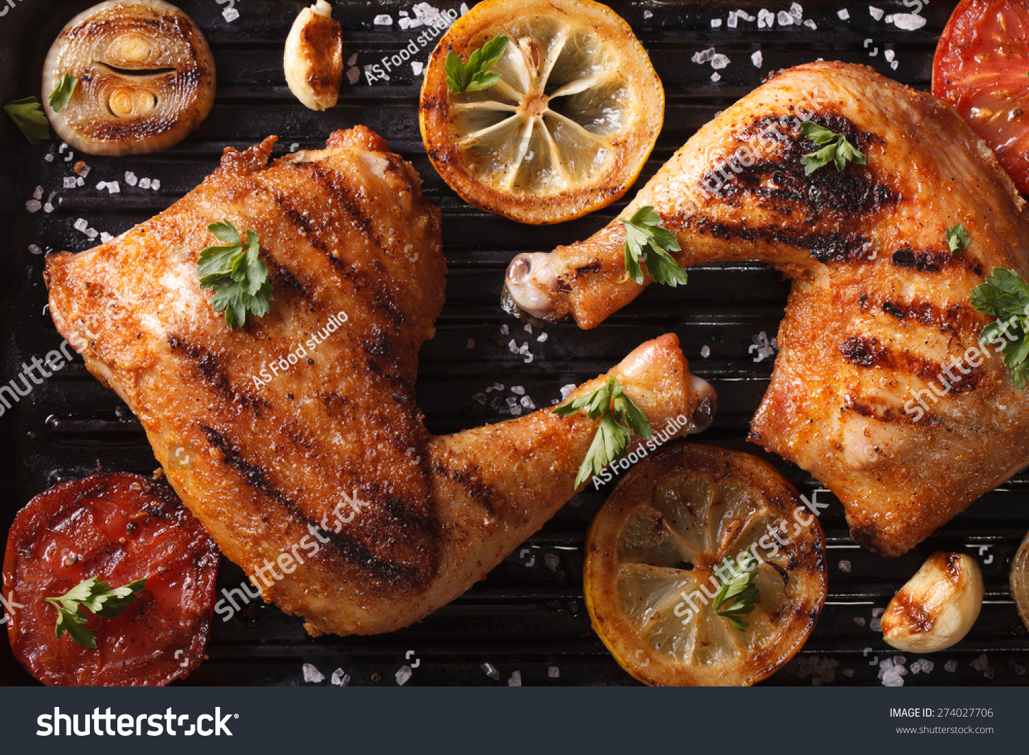 Two grilled chicken legs and vegetables on the grill pan macro. horizontal view from above
 #274027706