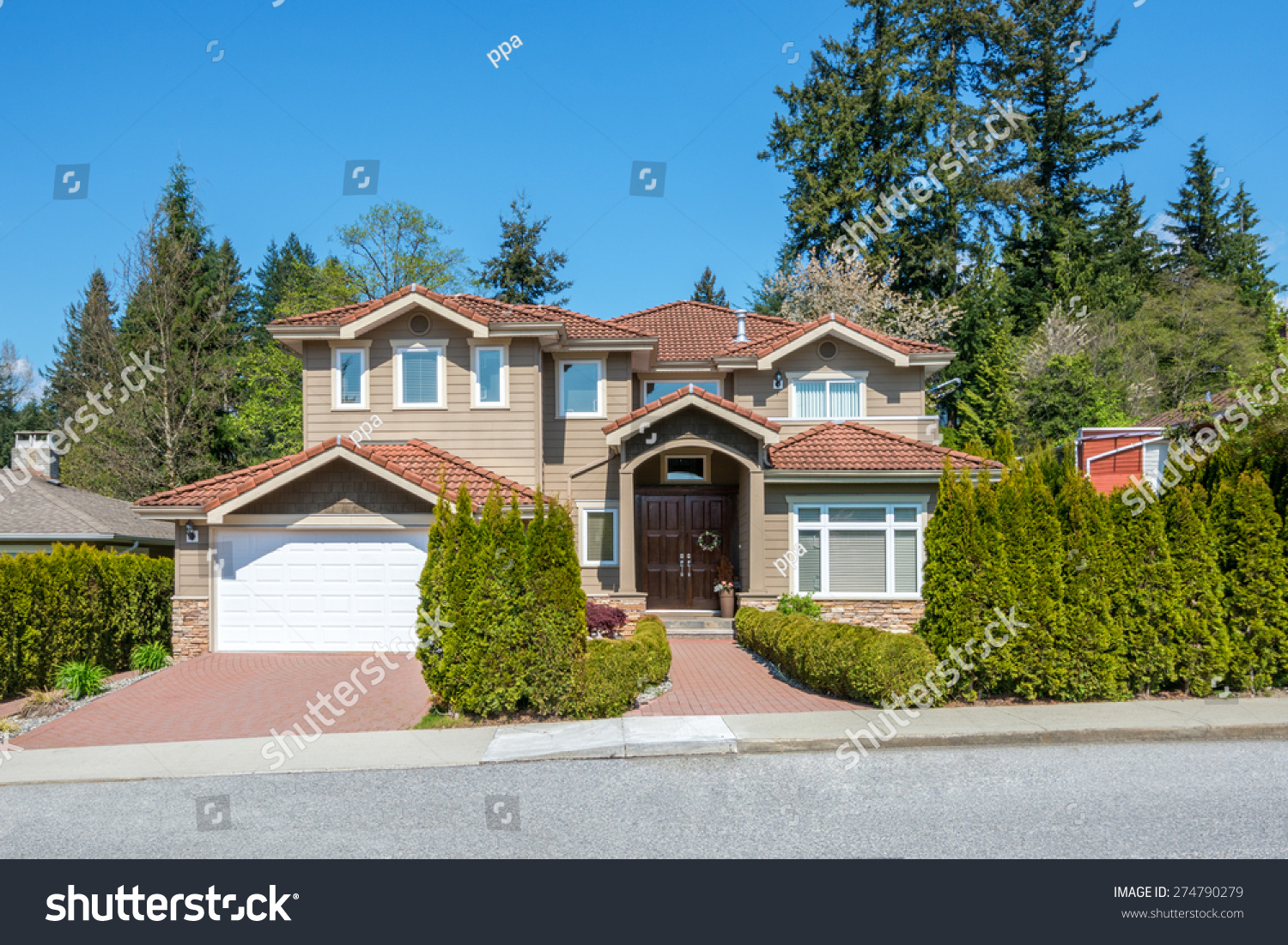 Luxury house with beautiful landscaping on a sunny day. Home exterior. #274790279