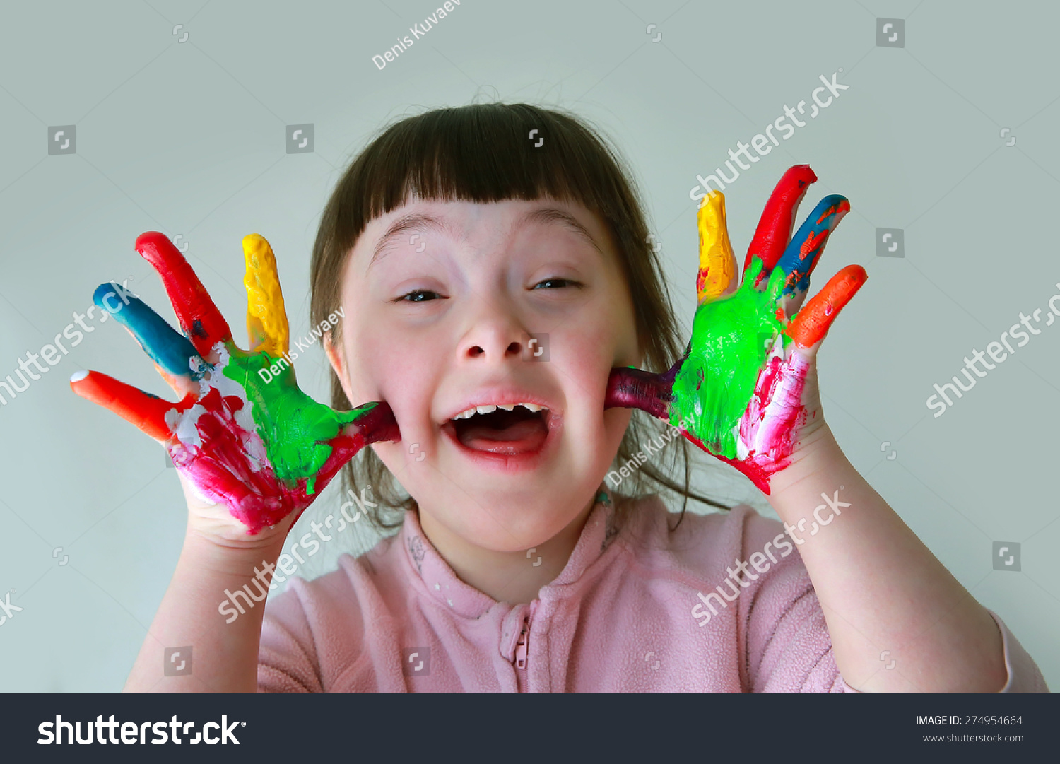 Cute little girl with painted hands. Isolated on grey background. #274954664