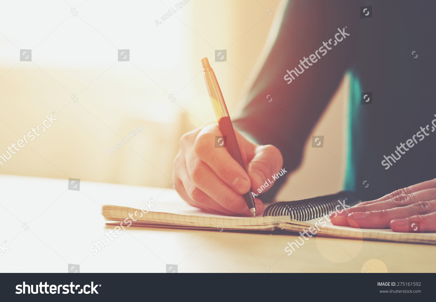 female hands with pen writing on notebook #275161592