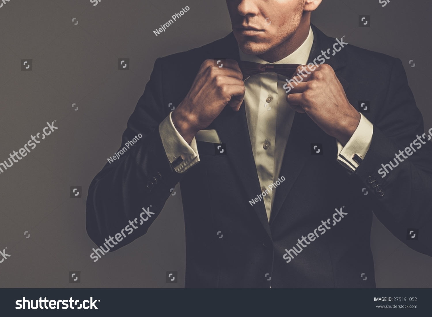 Sharp dressed man wearing jacket and bow tie #275191052