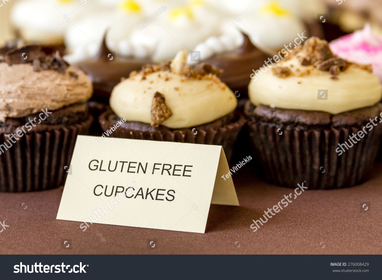 Display of assorted gluten free cupcakes sitting on display table #276008429